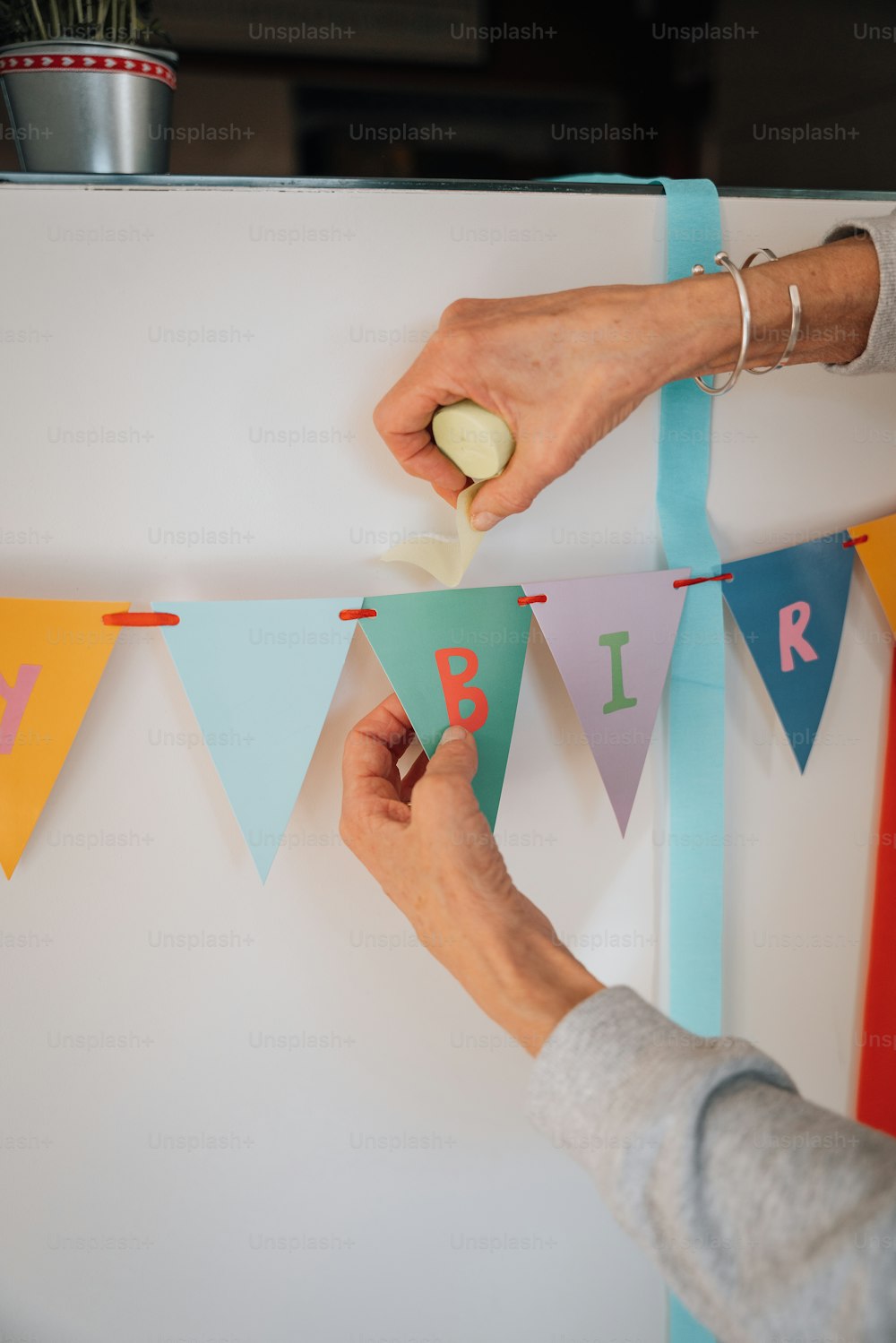 a woman is decorating a birthday banner