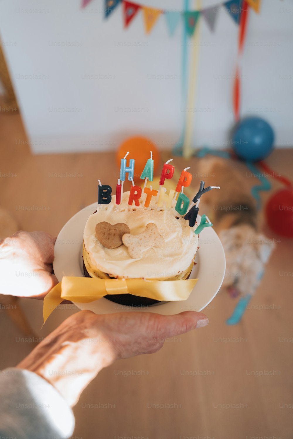 a person holding a birthday cake with candles