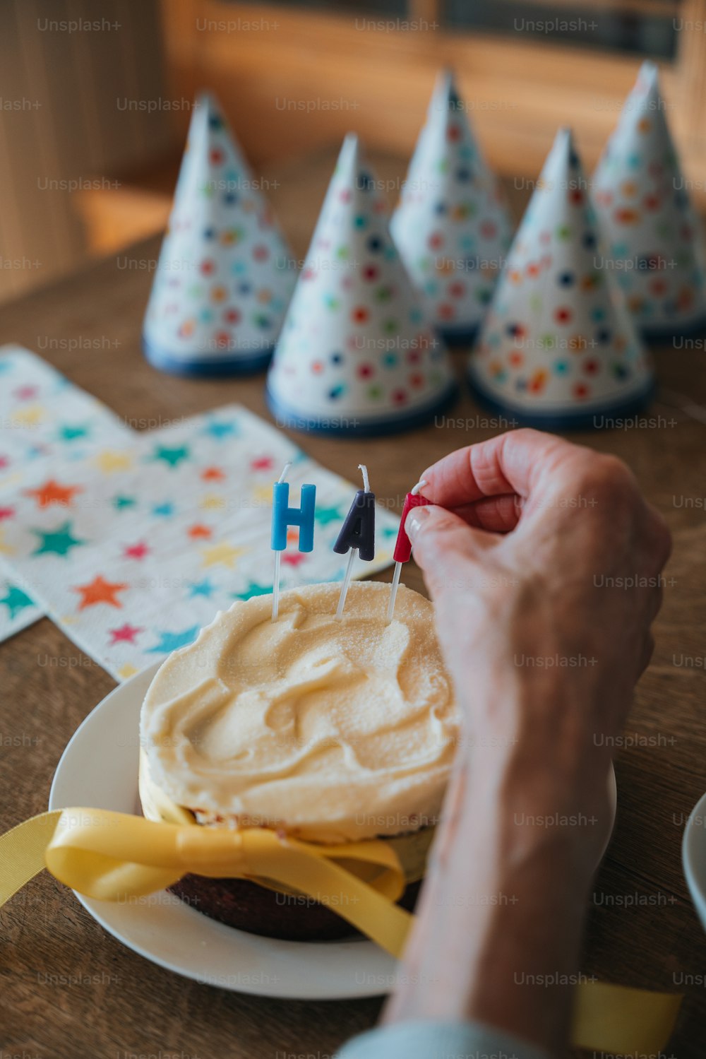 a person holding a piece of cake with candles on it