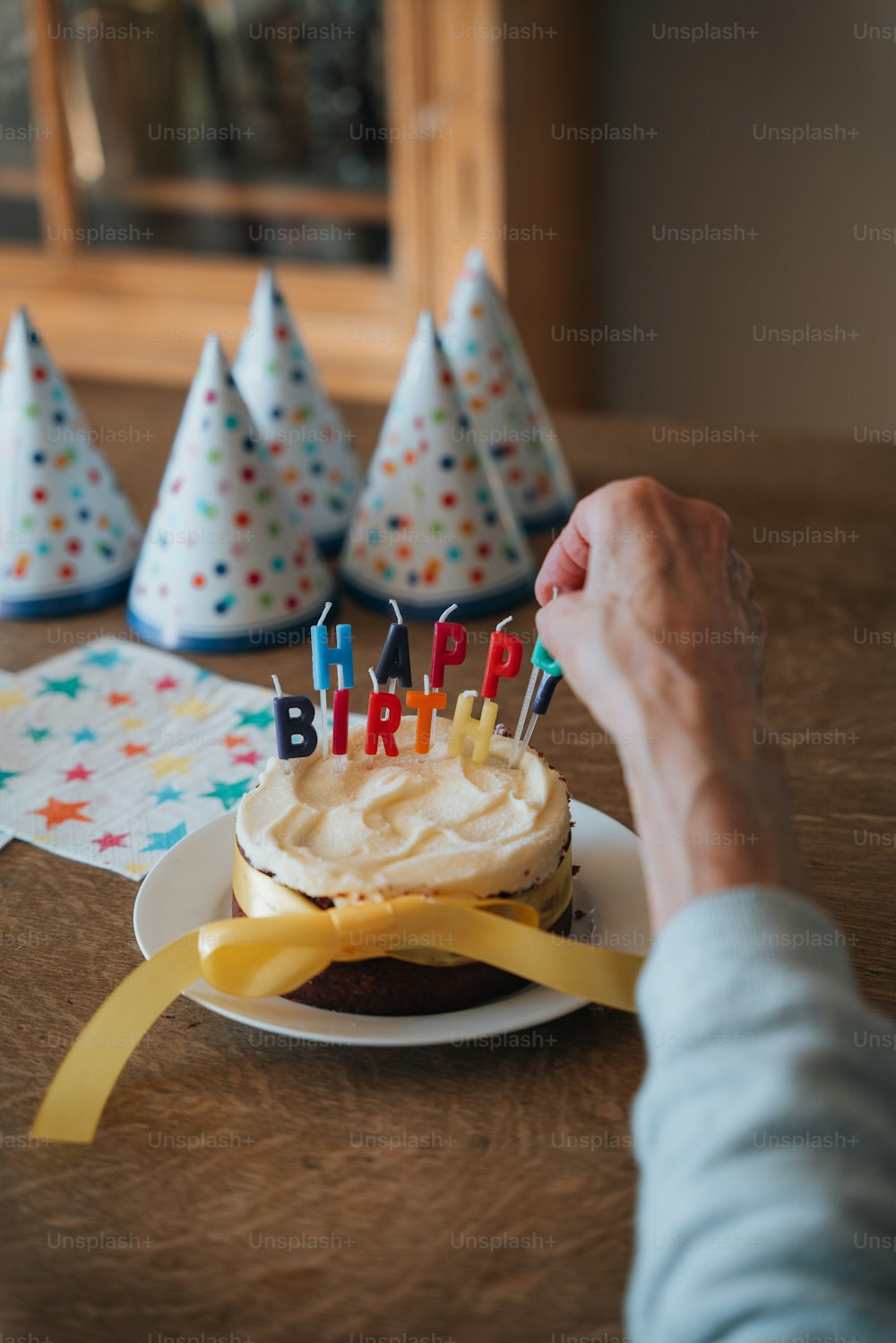 a person is holding a birthday cake with candles