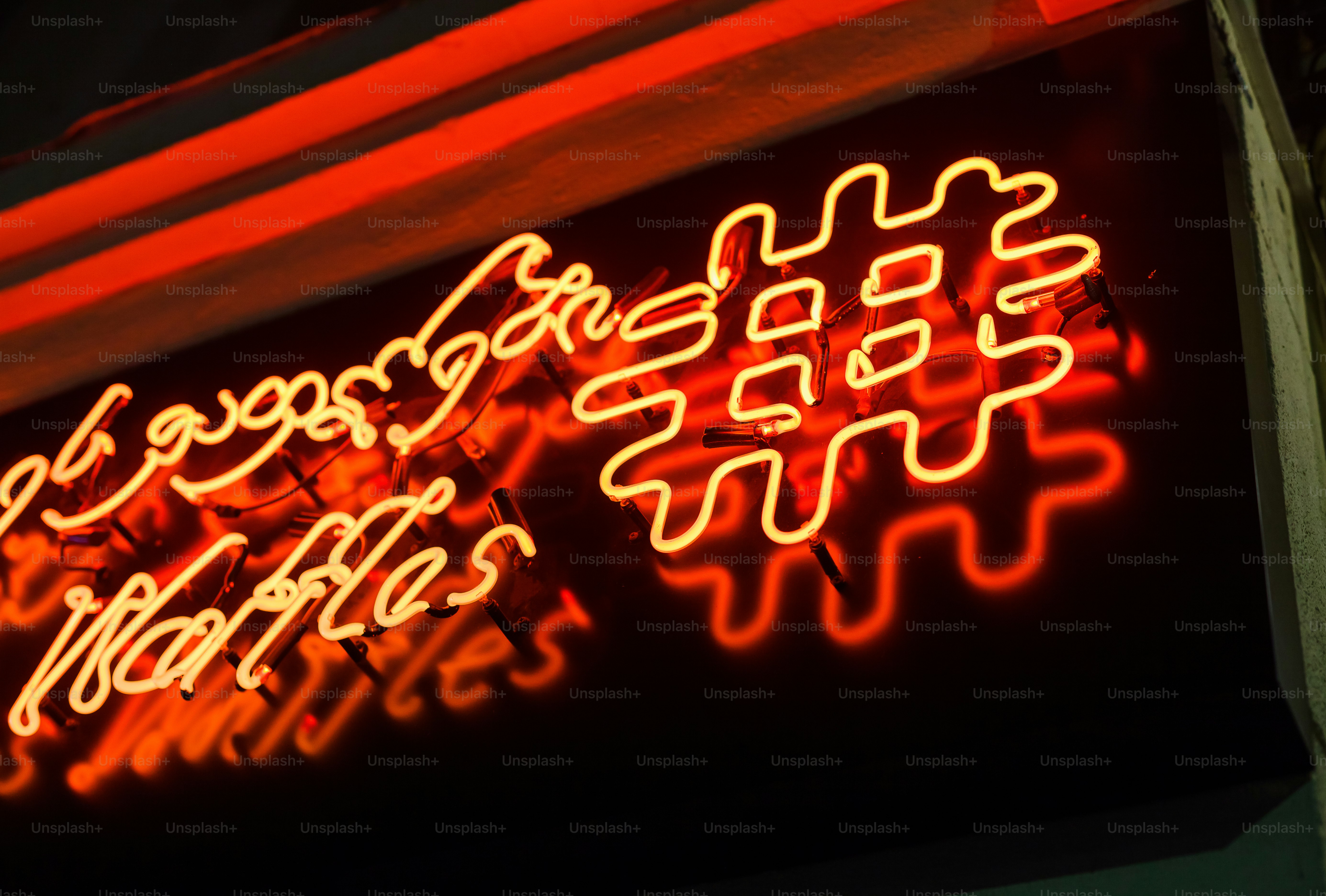 a close up of a neon sign on a building