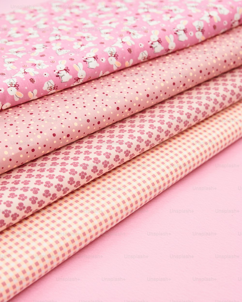 a pile of pink fabric sitting on top of a pink table