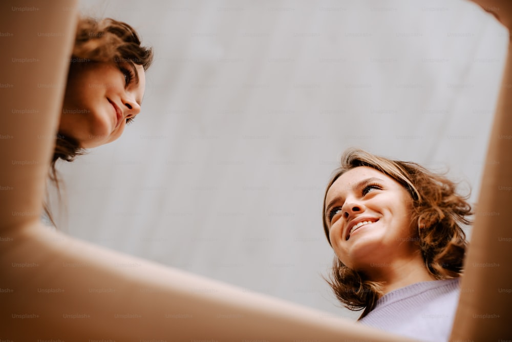 two women looking at each other through a mirror