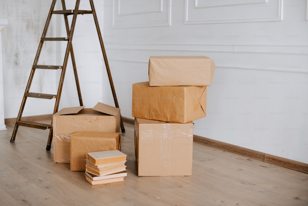 a pile of boxes sitting on top of a hard wood floor