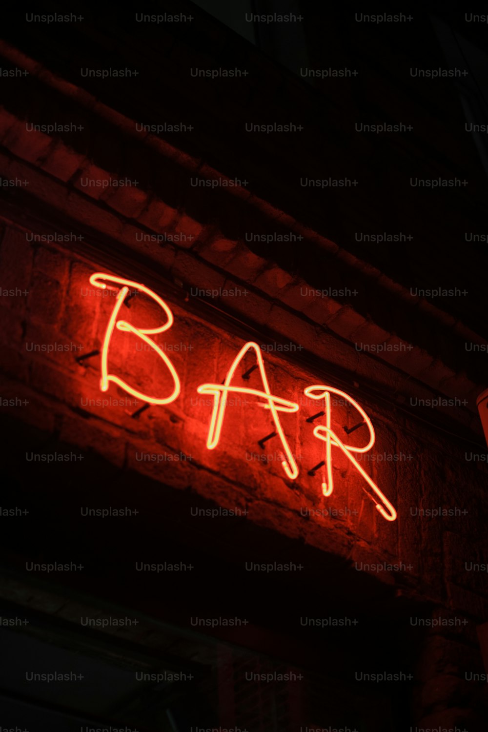 a neon sign that says bar on the side of a building