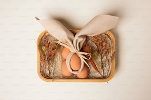 three eggs in a basket tied with a bow