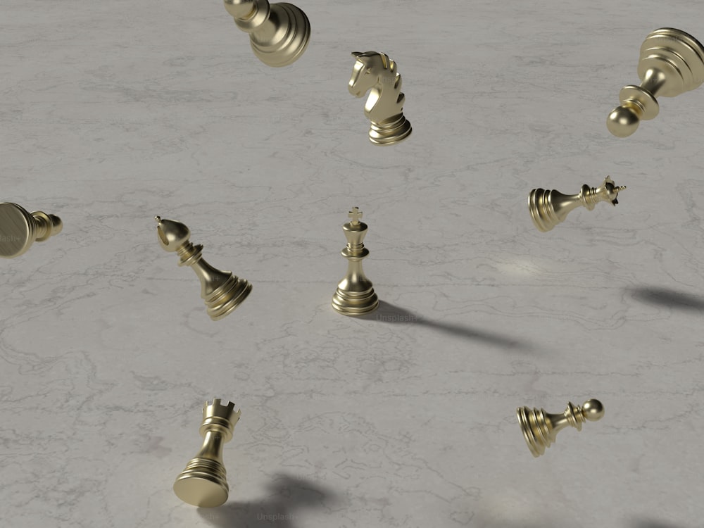 a group of gold chess pieces on a marble surface