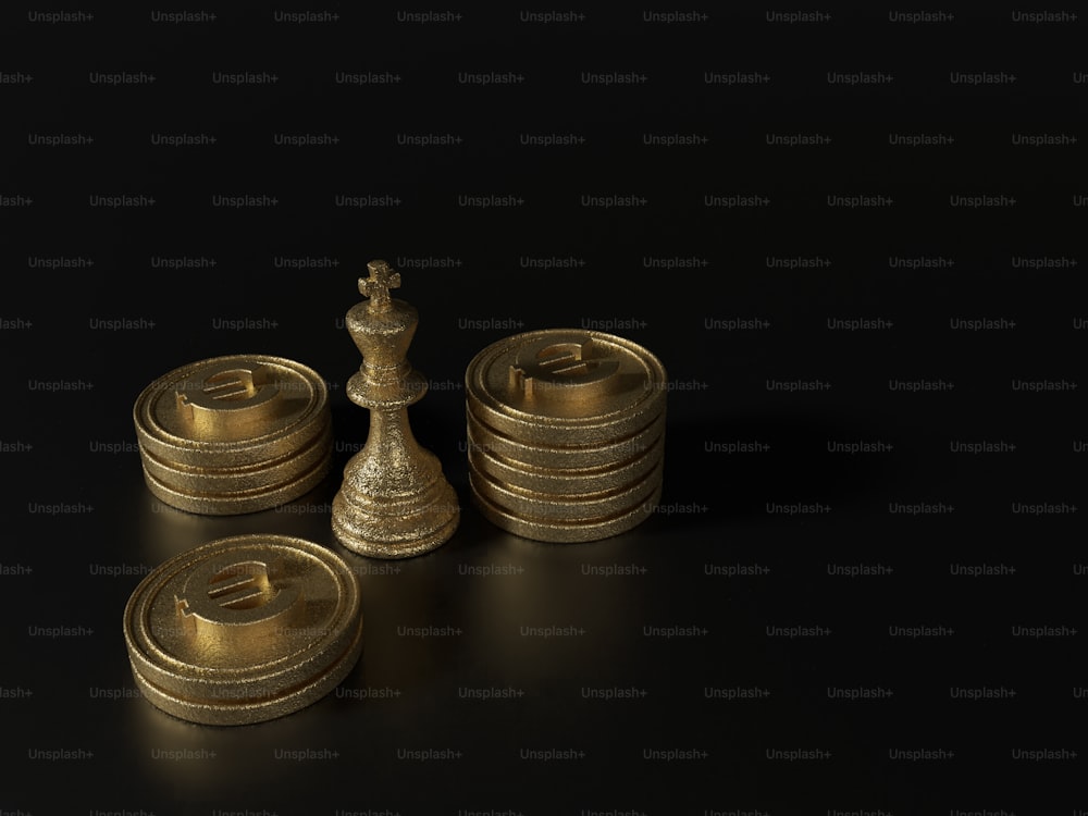 a set of gold chess pieces on a black background