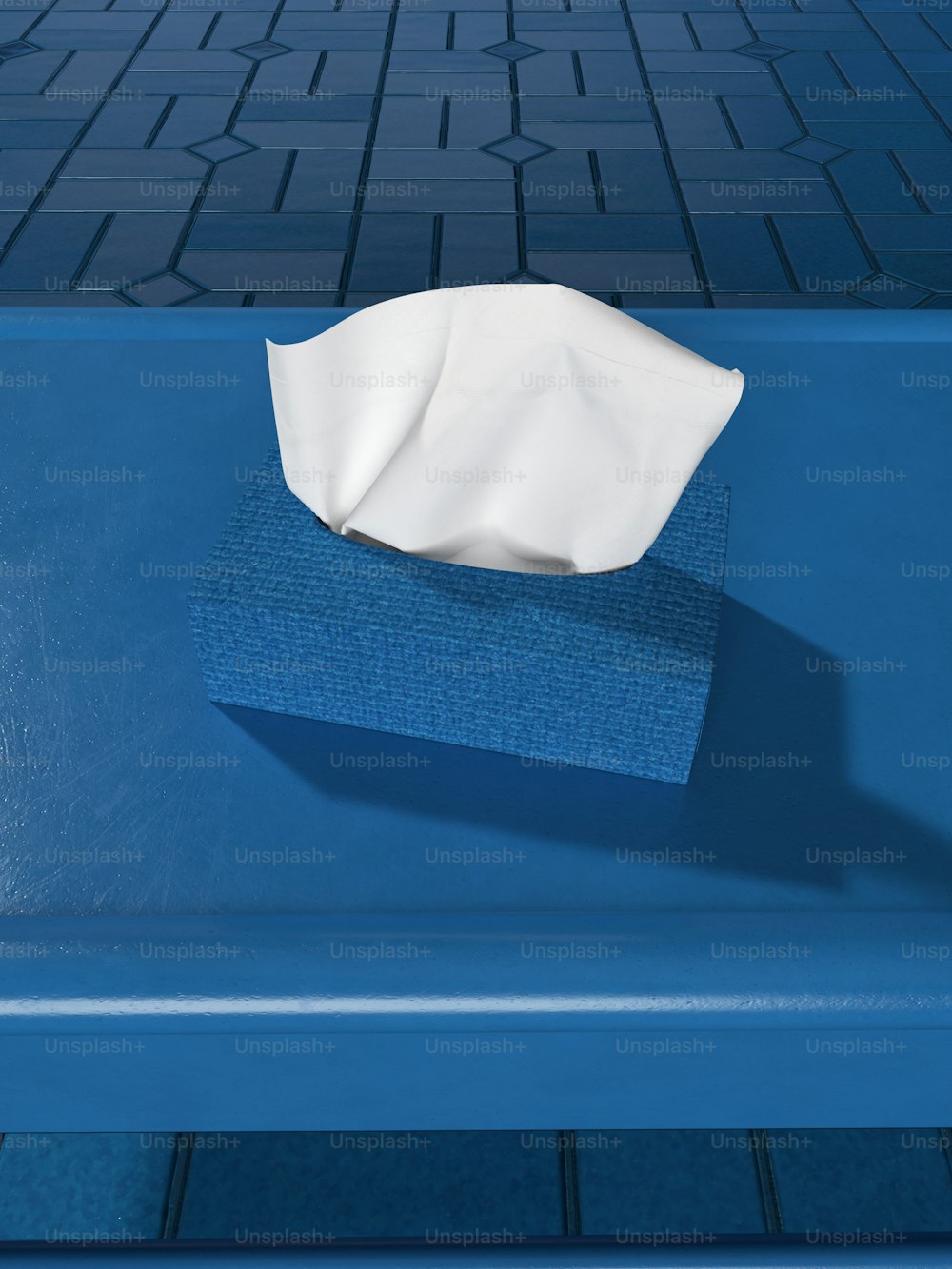 a blue bench with a napkin on top of it