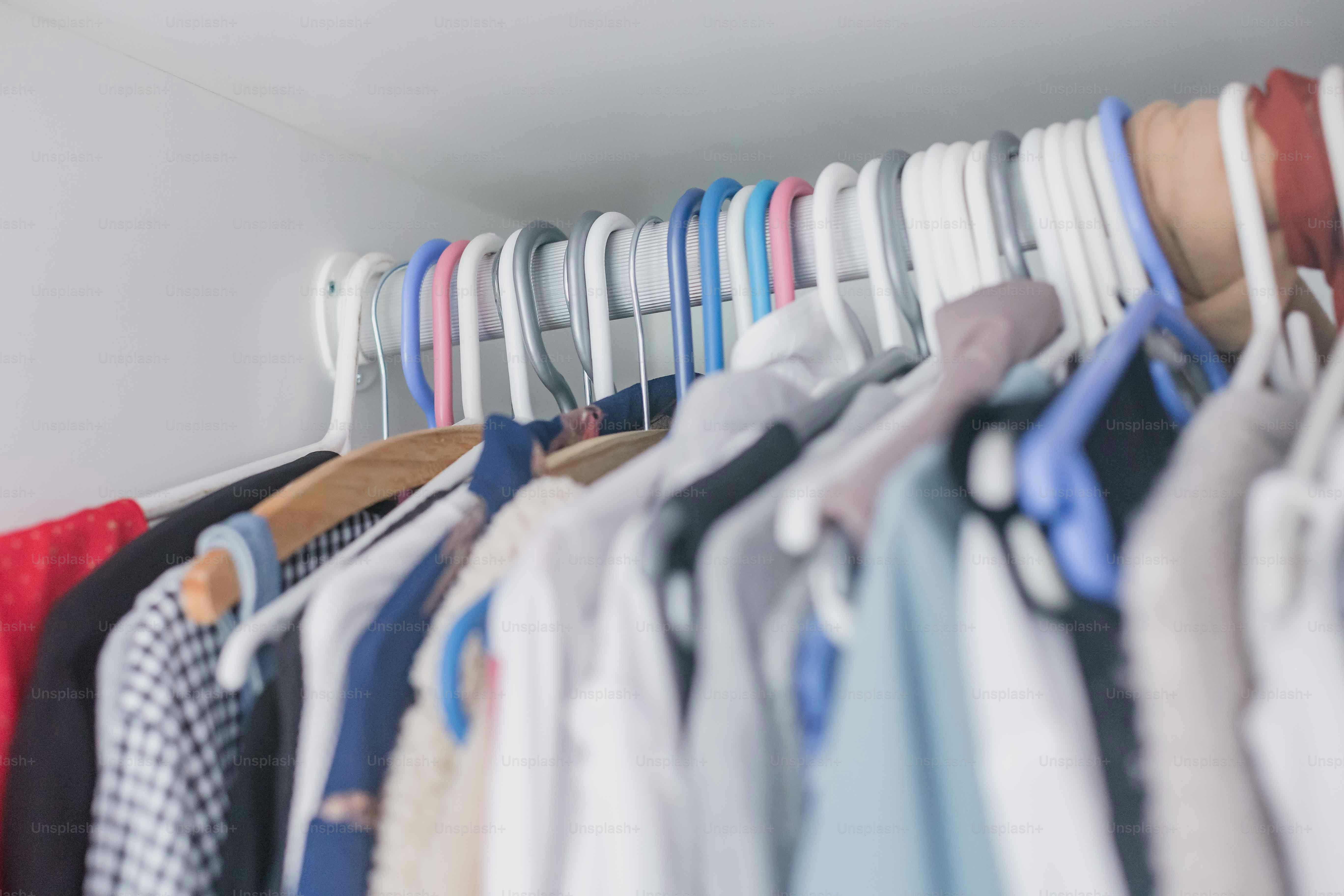 a bunch of shirts hanging on a rack