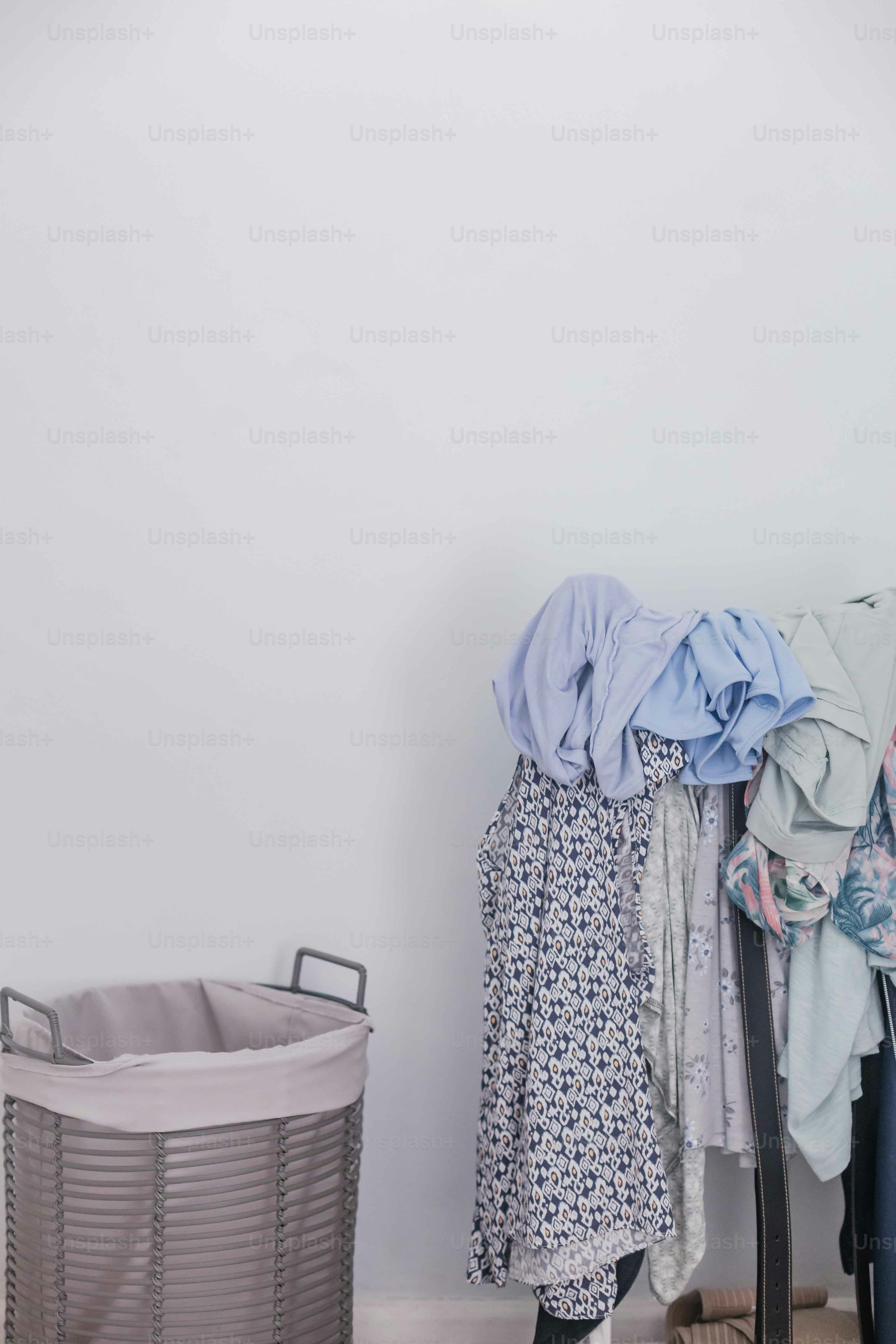 a woman standing next to a laundry basket