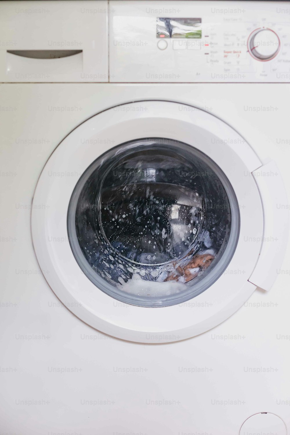 um close up de uma máquina de lavar roupa com água dentro