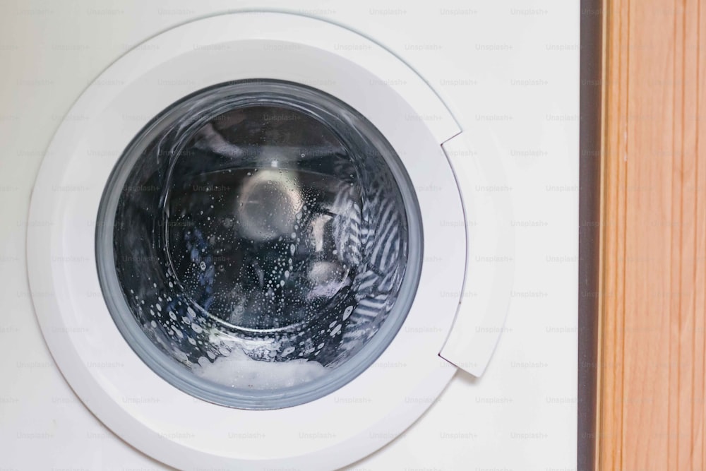 Un primer plano de una lavadora con agua en su interior
