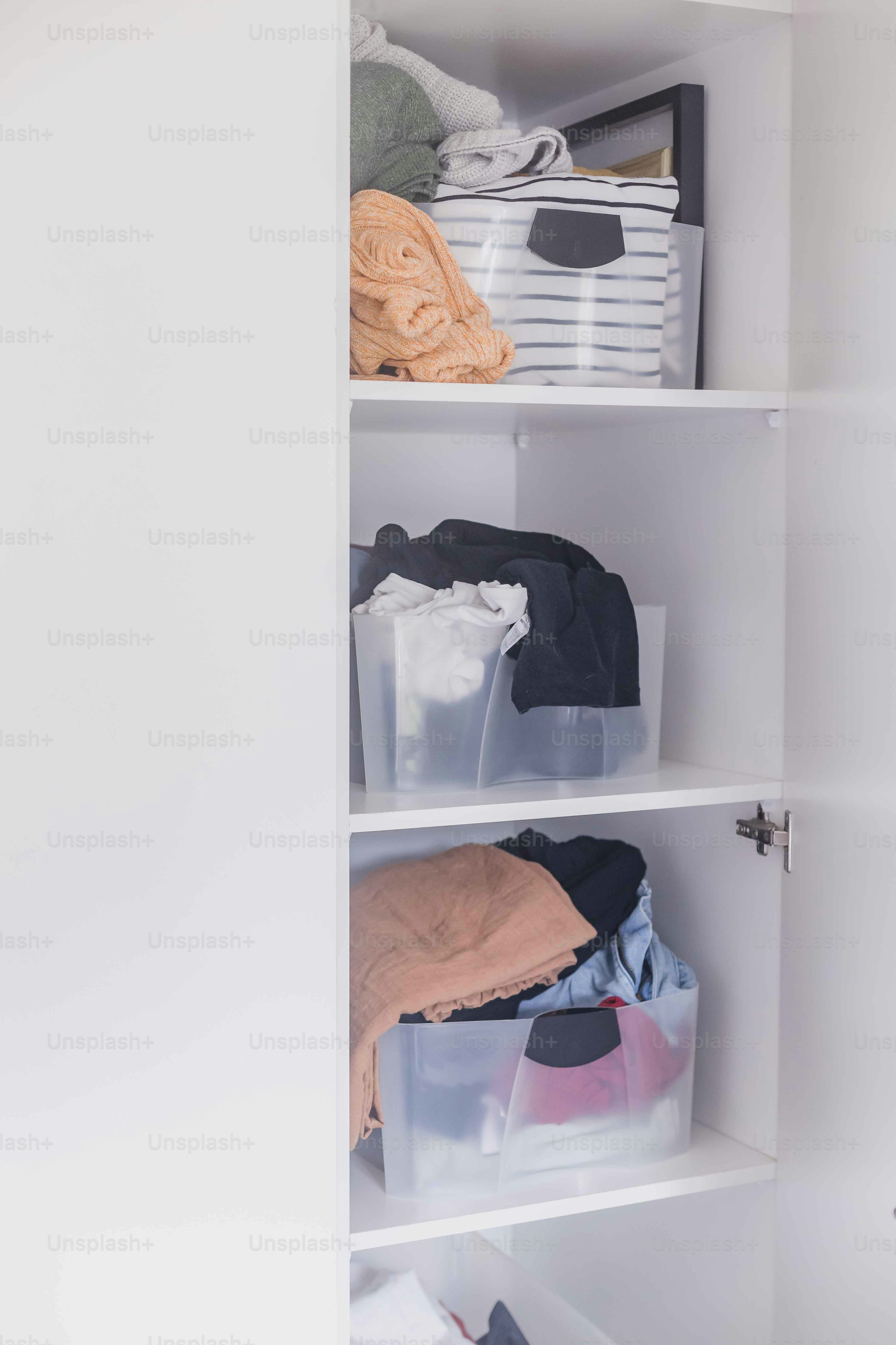 a closet filled with lots of different types of clothes