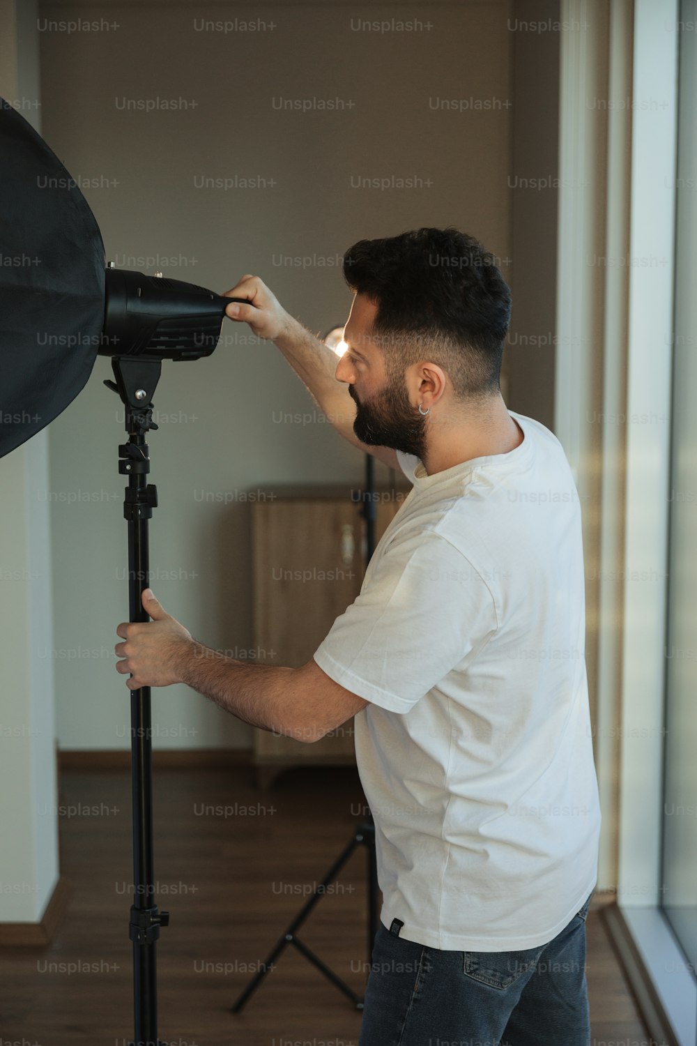 a man standing in front of a camera on a tripod