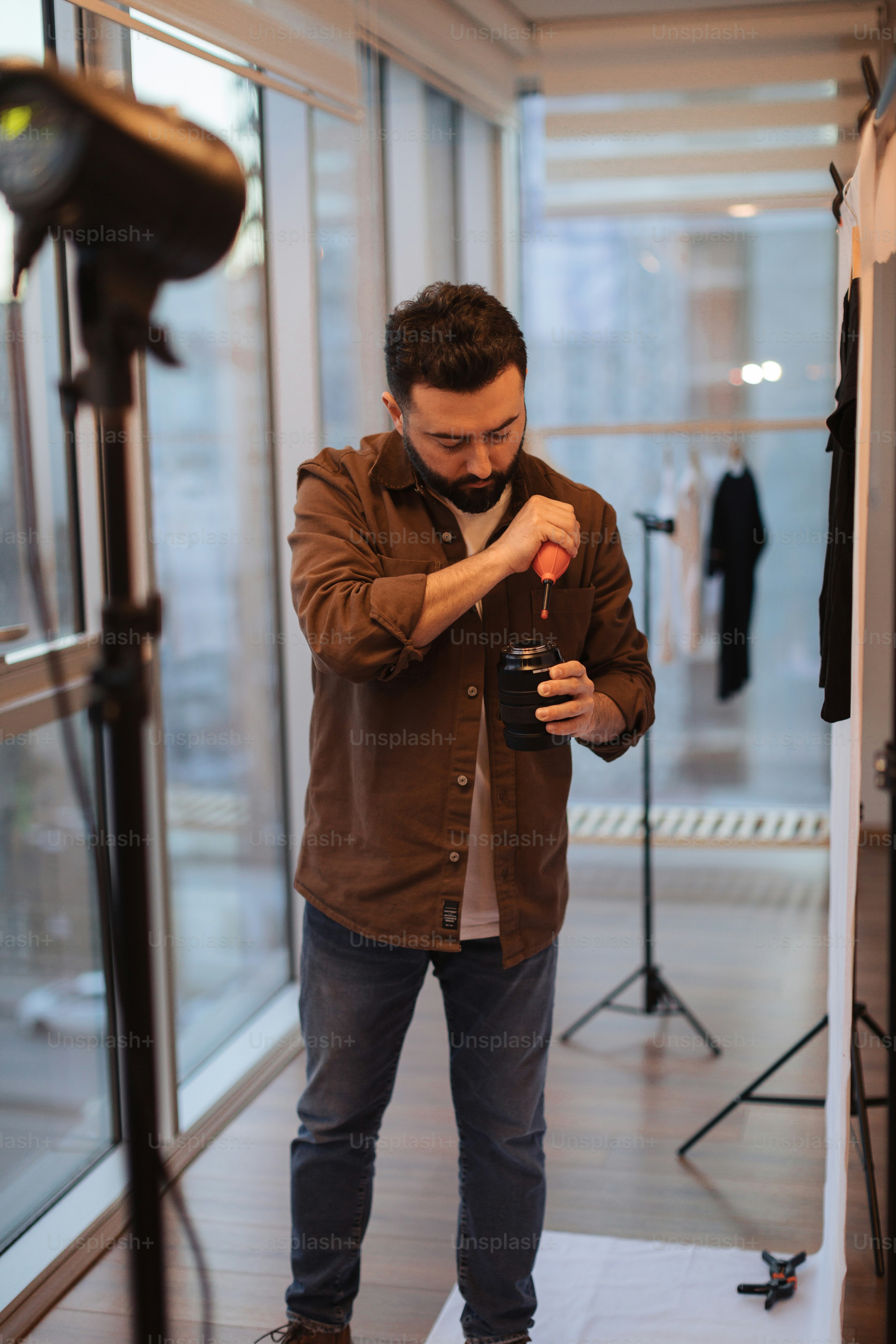 a man standing in front of a mirror holding a camera
