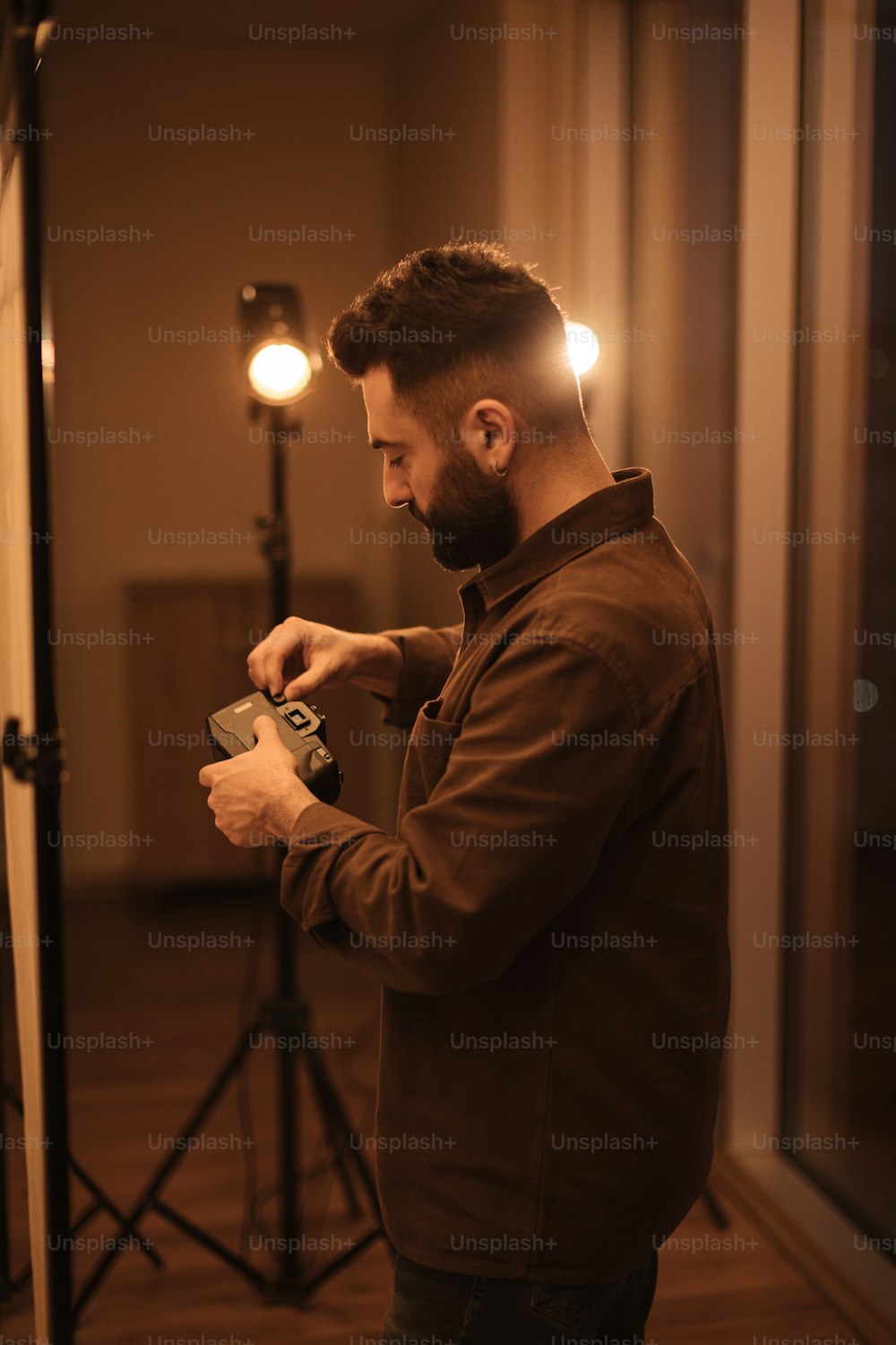 a man standing in a room holding a camera