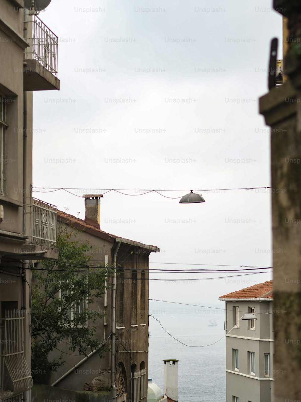 a view of the ocean from an alley way