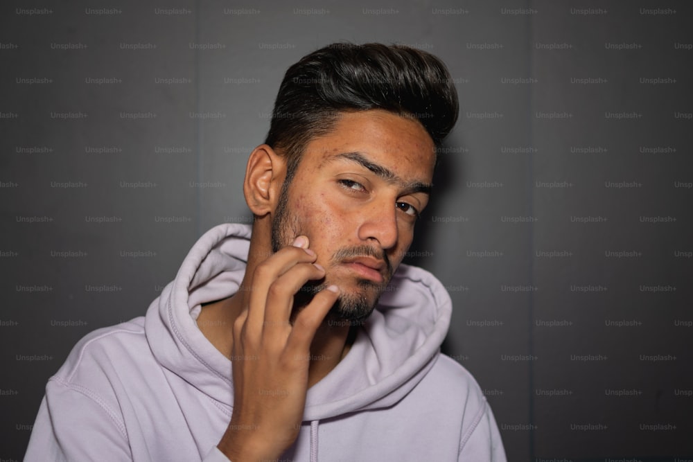 a man in a hoodie talking on a cell phone
