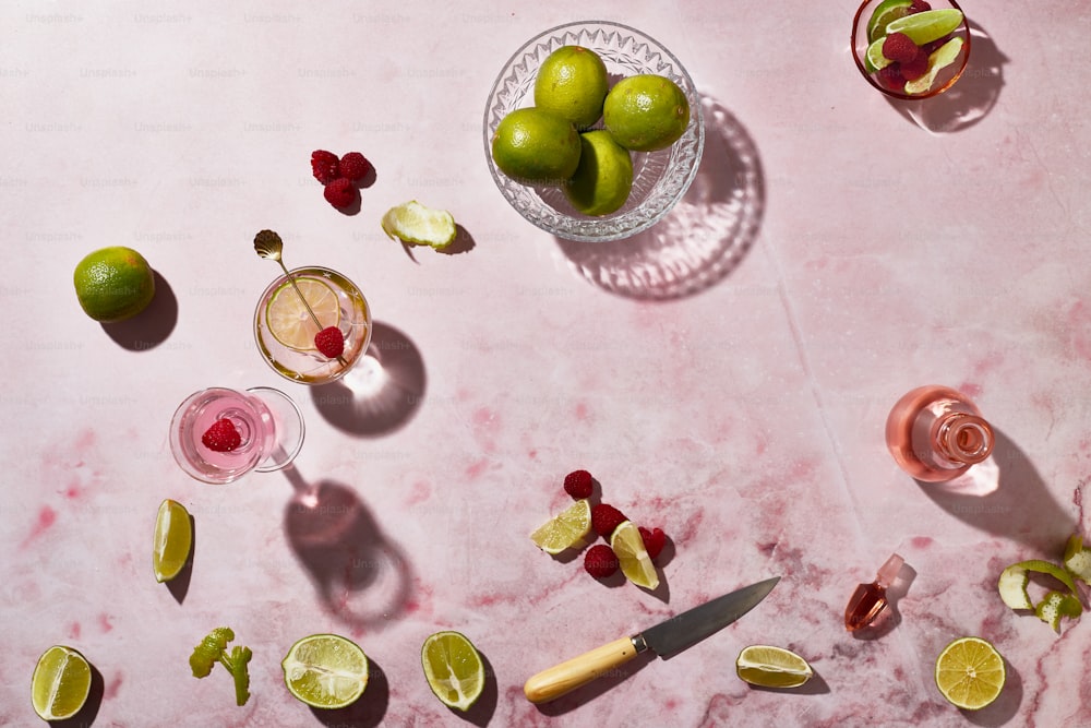 limes, raspberries, limes, and limeade on a table