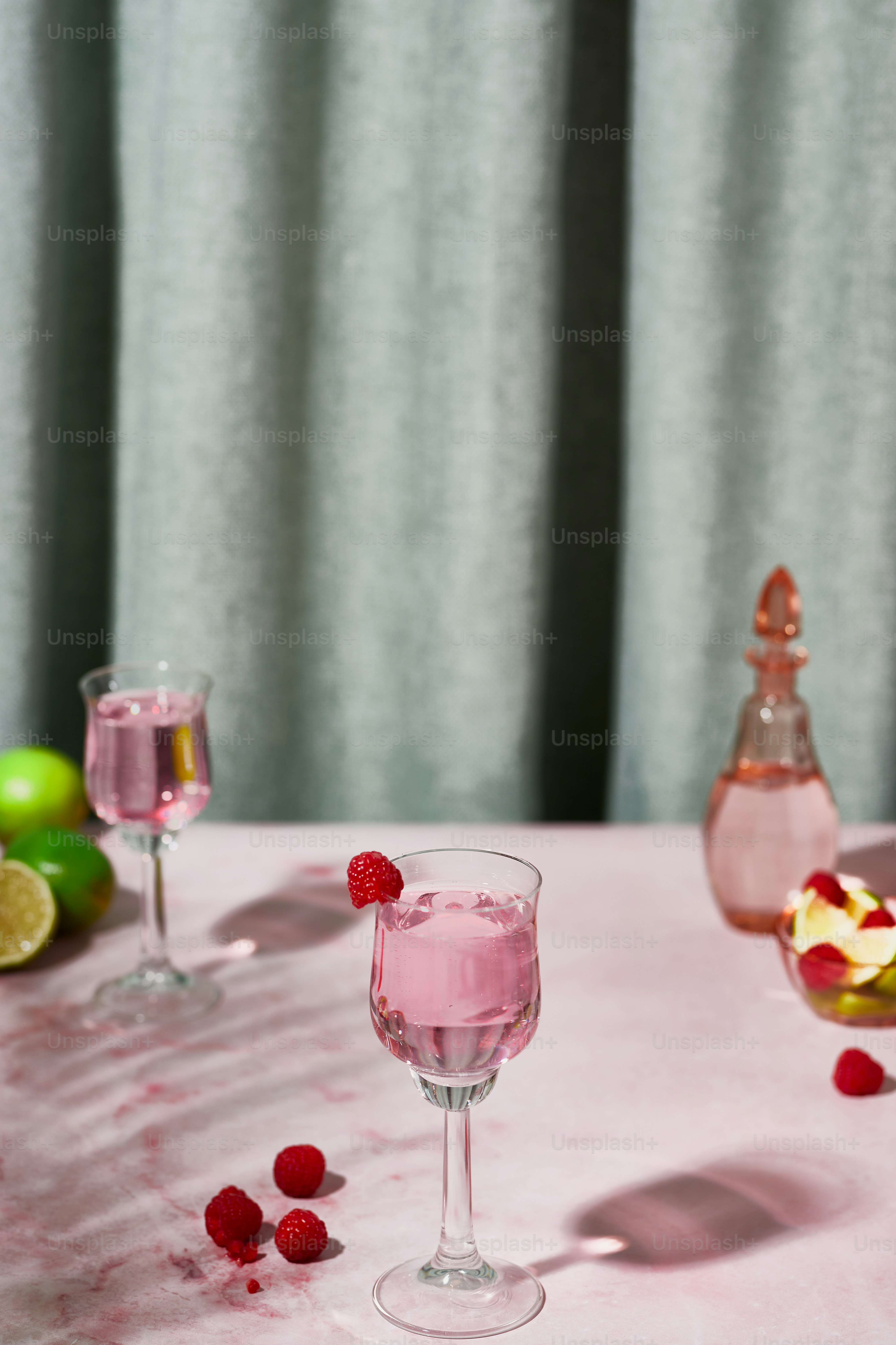 two glasses of raspberry wine on a table