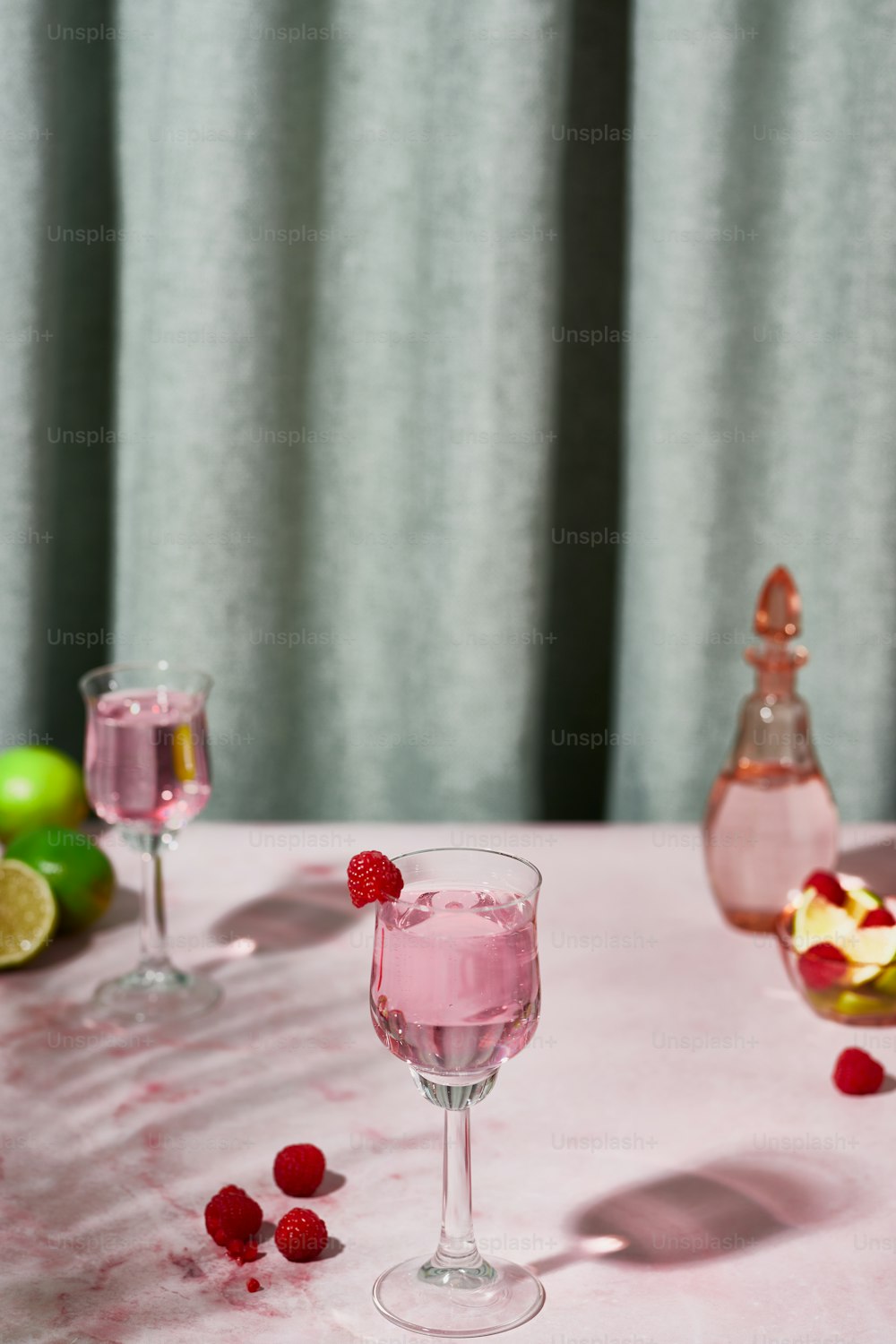 two glasses of raspberry wine on a table