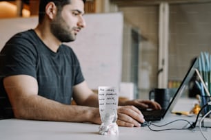 a man sitting in front of a laptop computer