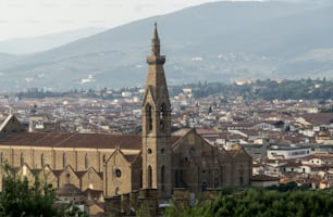 a large church tower towering over a city