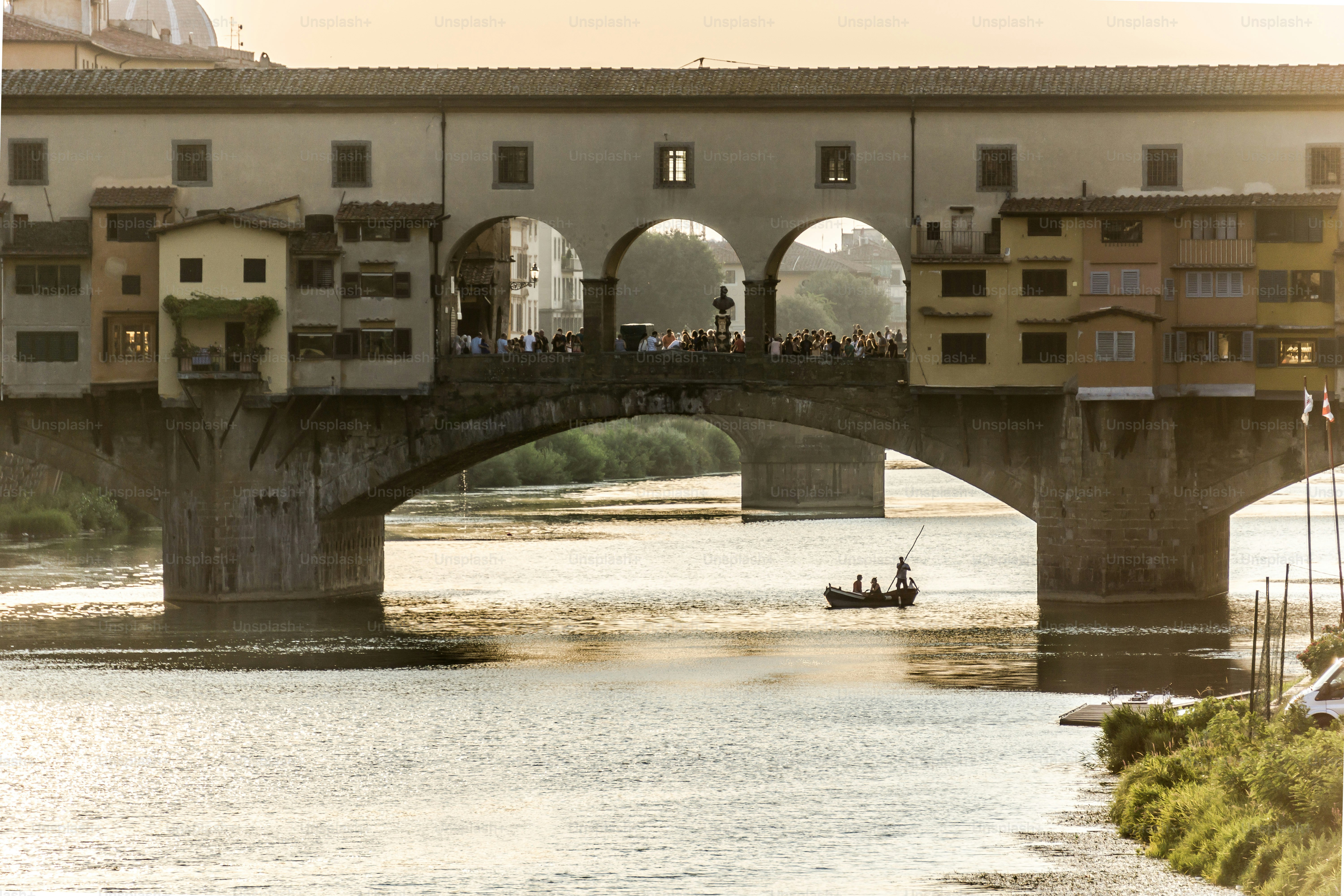 a group of people on a bridge over a river