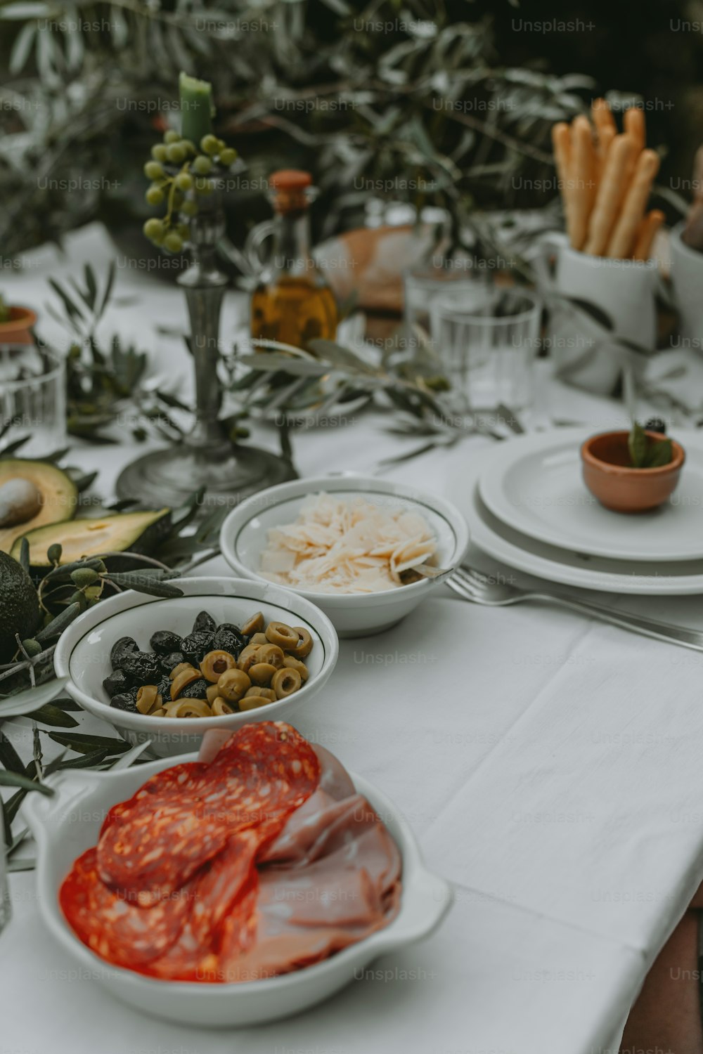 a table with plates and bowls of food on it