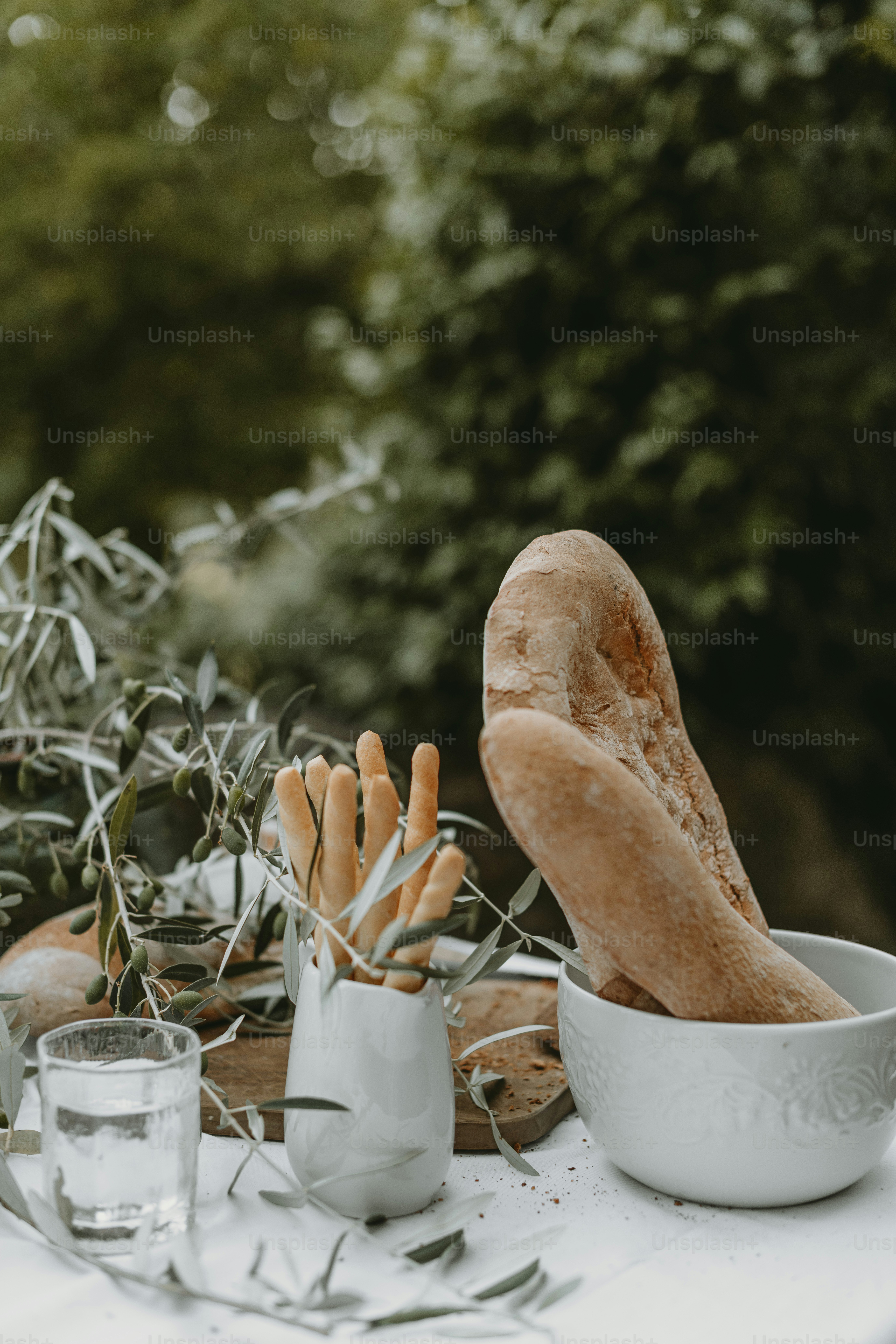 a table topped with a bowl filled with bread
