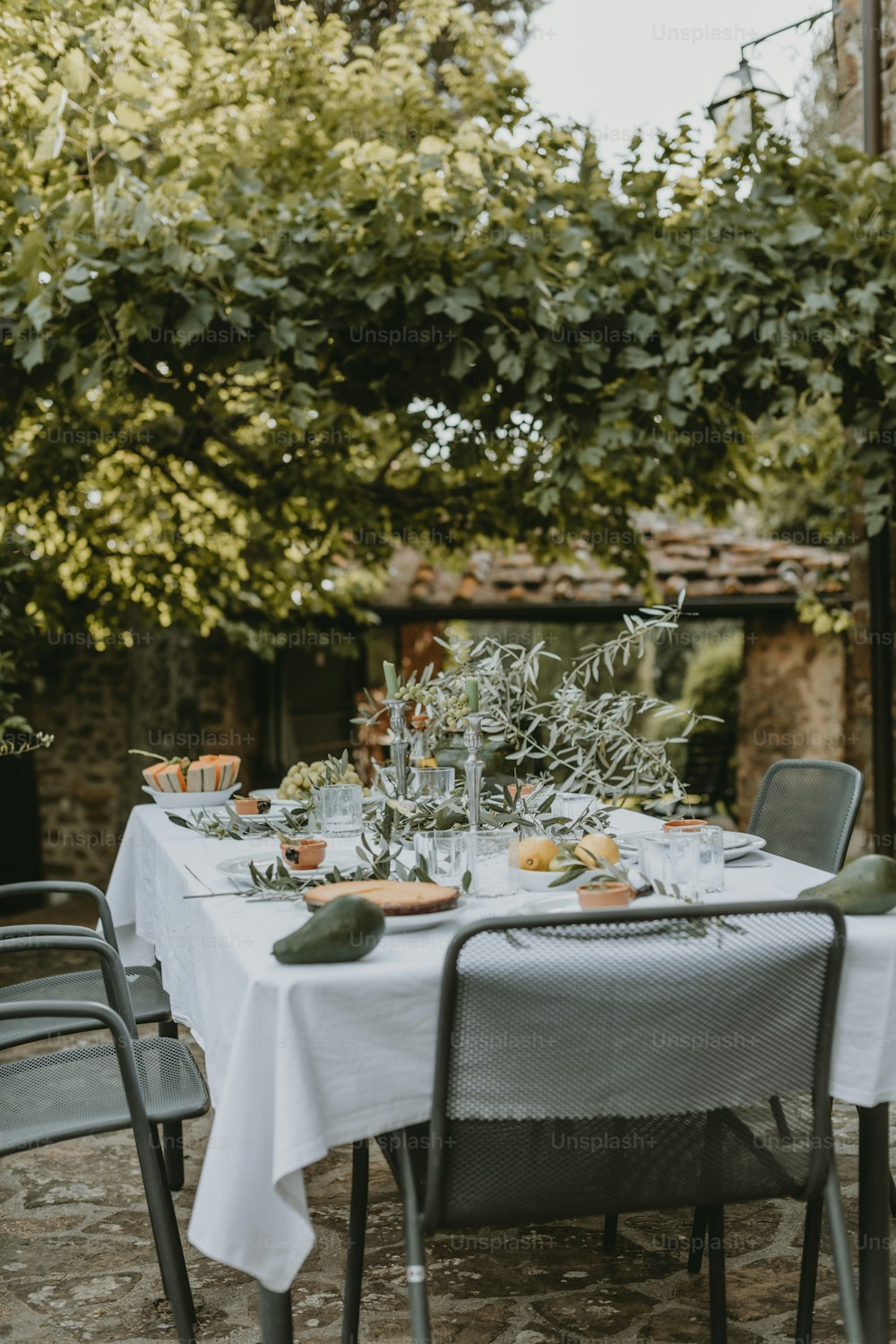 a table with a white table cloth is set outside