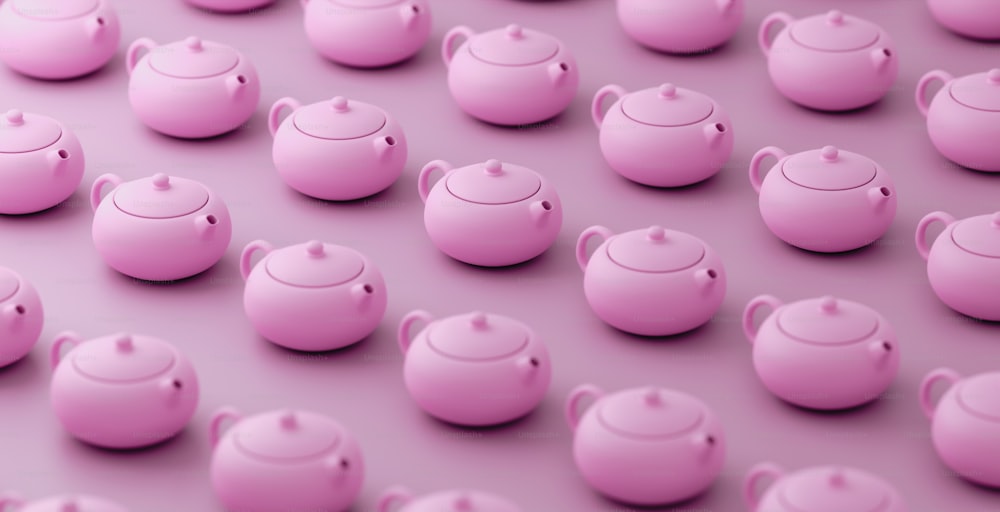 a group of pink teapots sitting next to each other