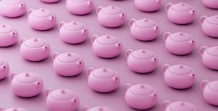 a group of pink teapots sitting next to each other