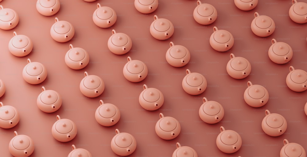 a group of small pink objects on a pink surface