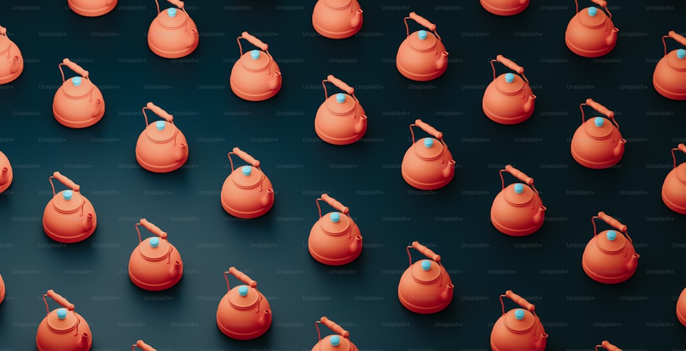 a group of orange kettles with a blue top