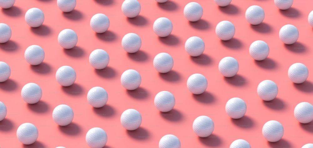 a group of white balls sitting on top of a pink surface
