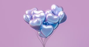 a bunch of heart shaped balloons floating in the air