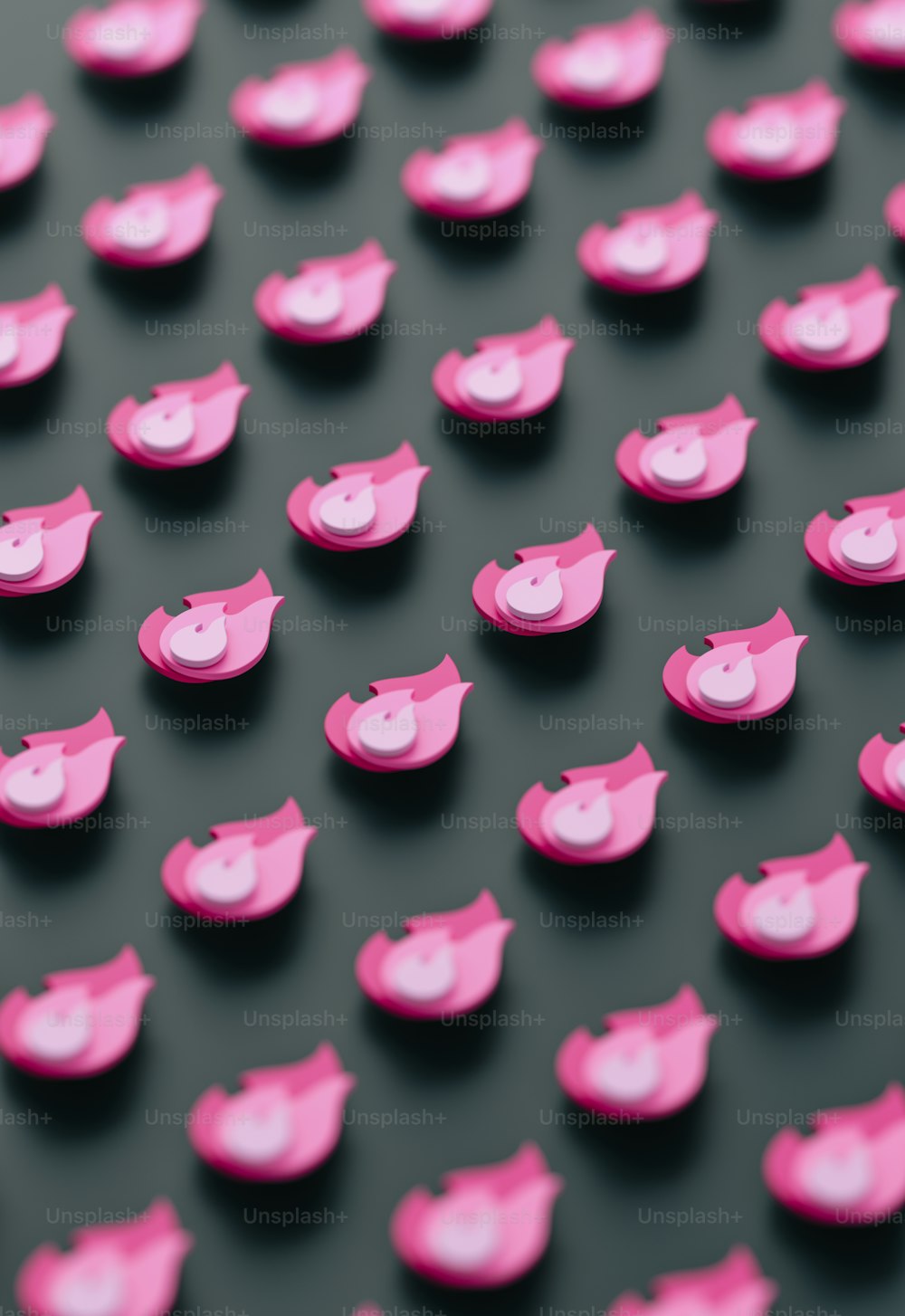 a close up of pink buttons on a black surface