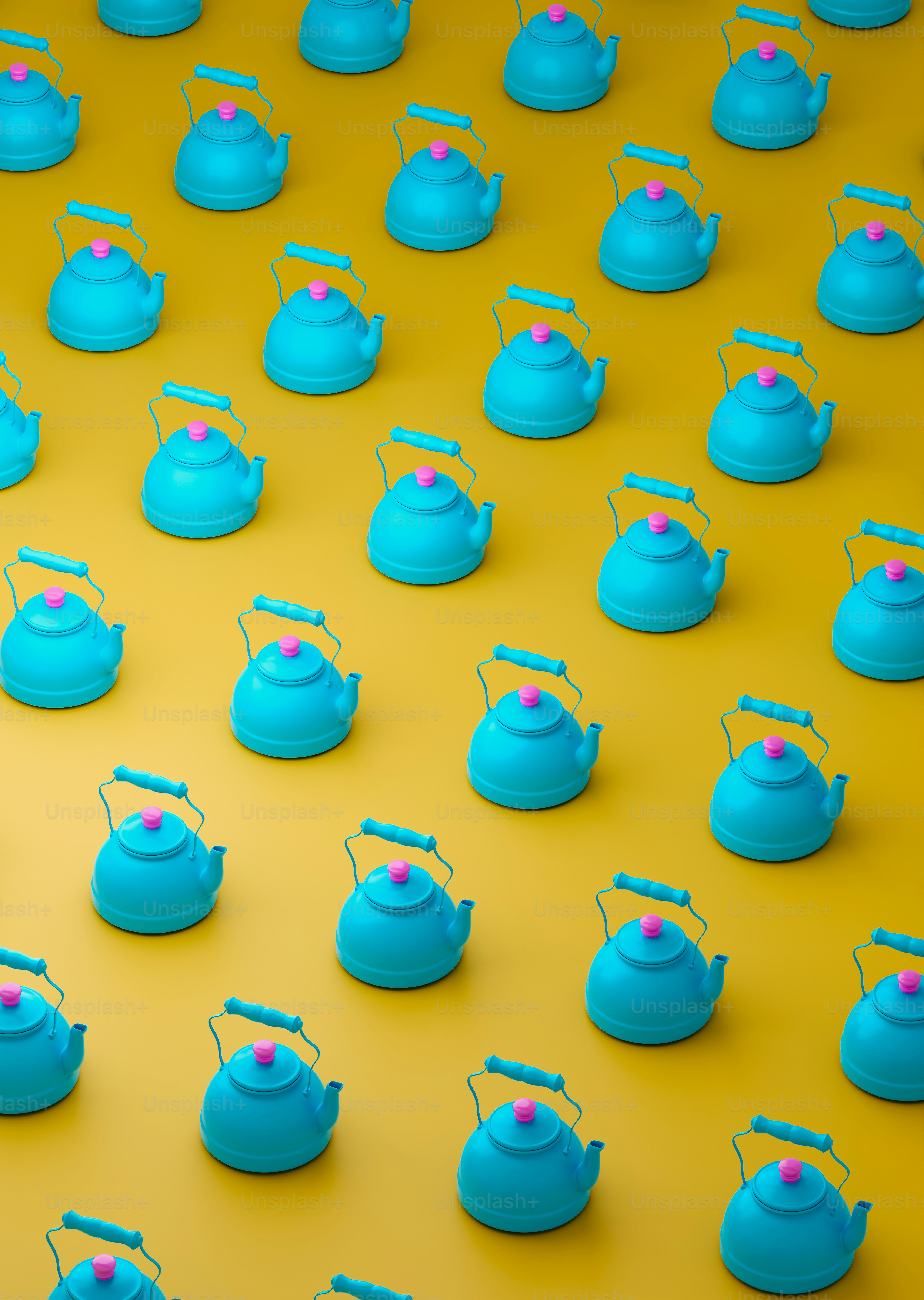 a group of tea kettles sitting on top of a yellow surface
