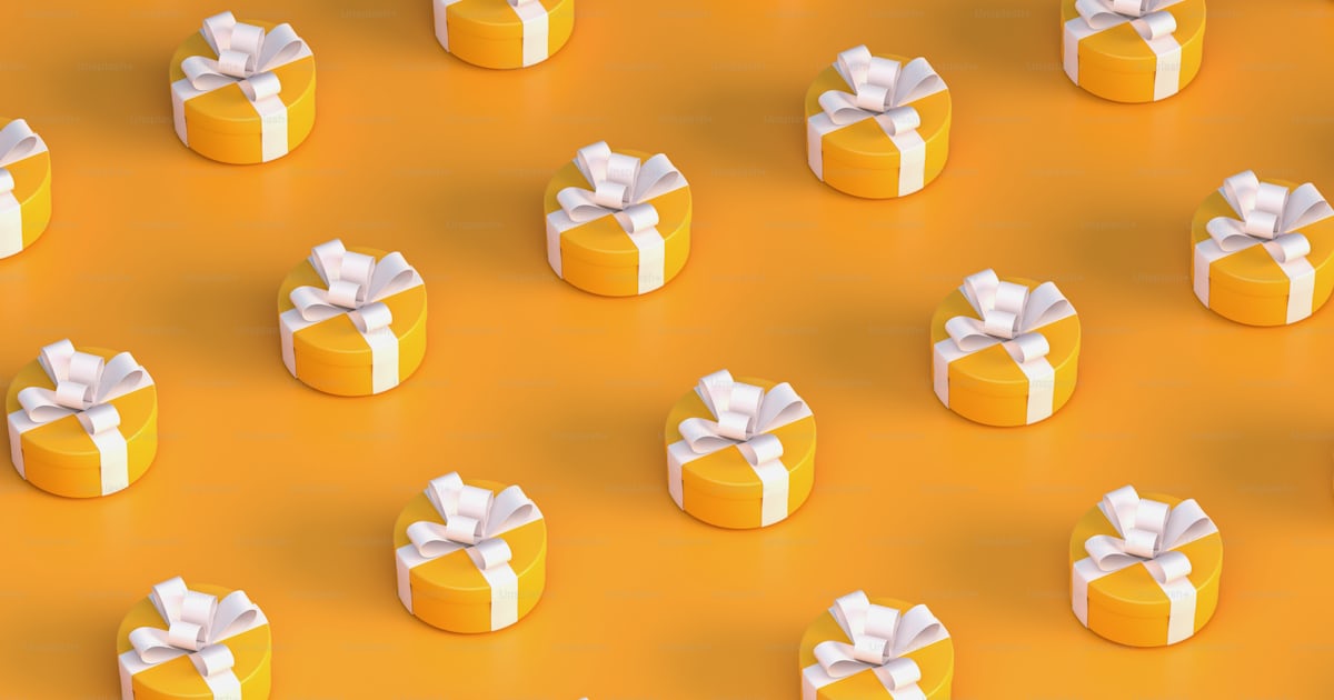 A group of yellow boxes with white bows photo – Laptop wallpaper Image