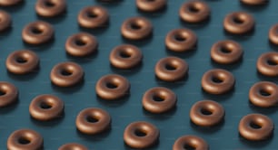 a group of chocolate donuts sitting on top of a table