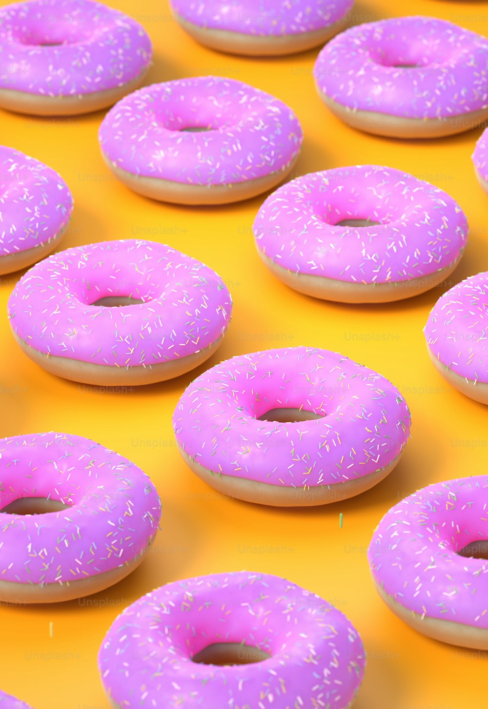 a bunch of pink donuts with sprinkles on them