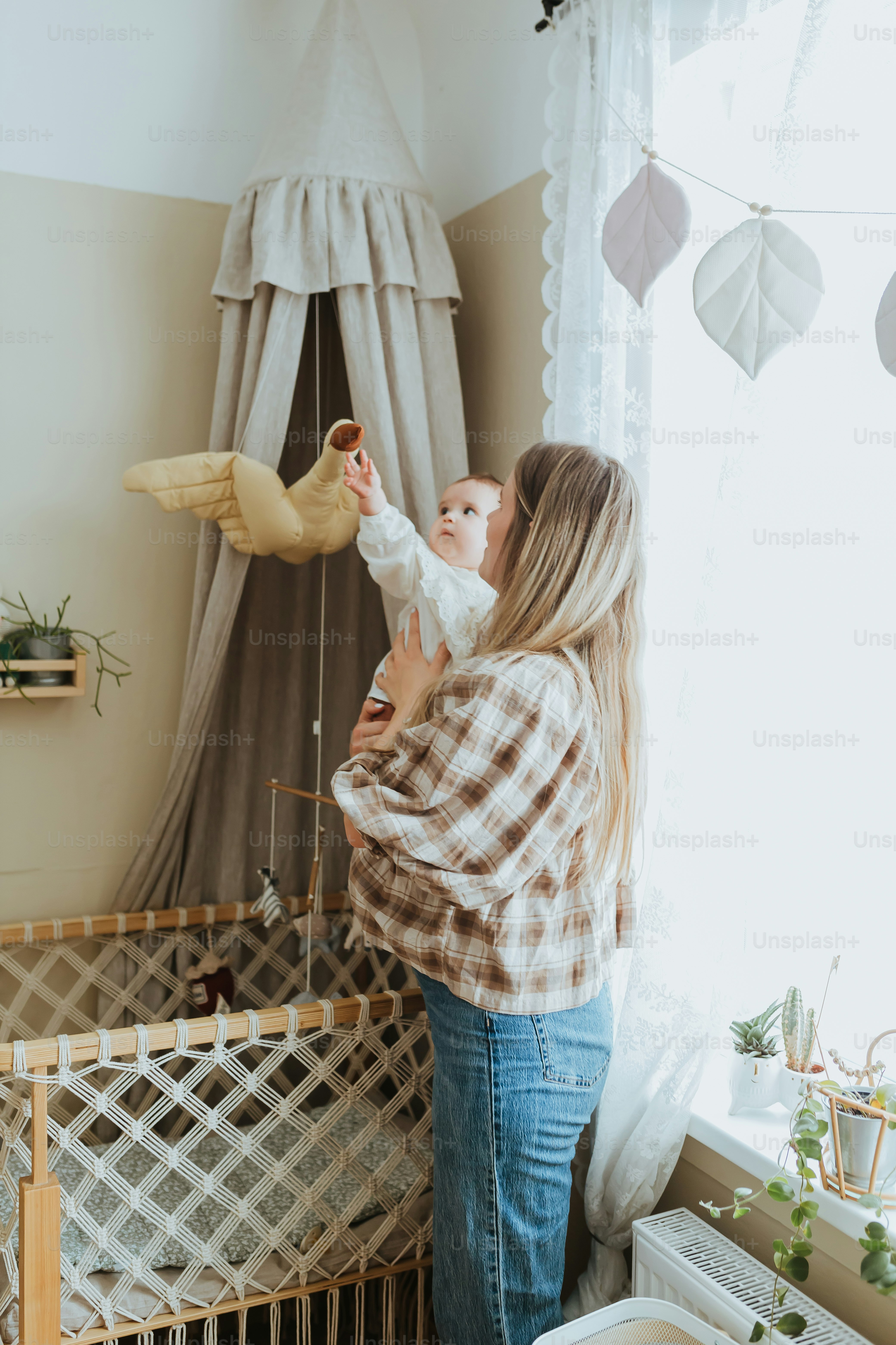 a woman holding a baby in a crib