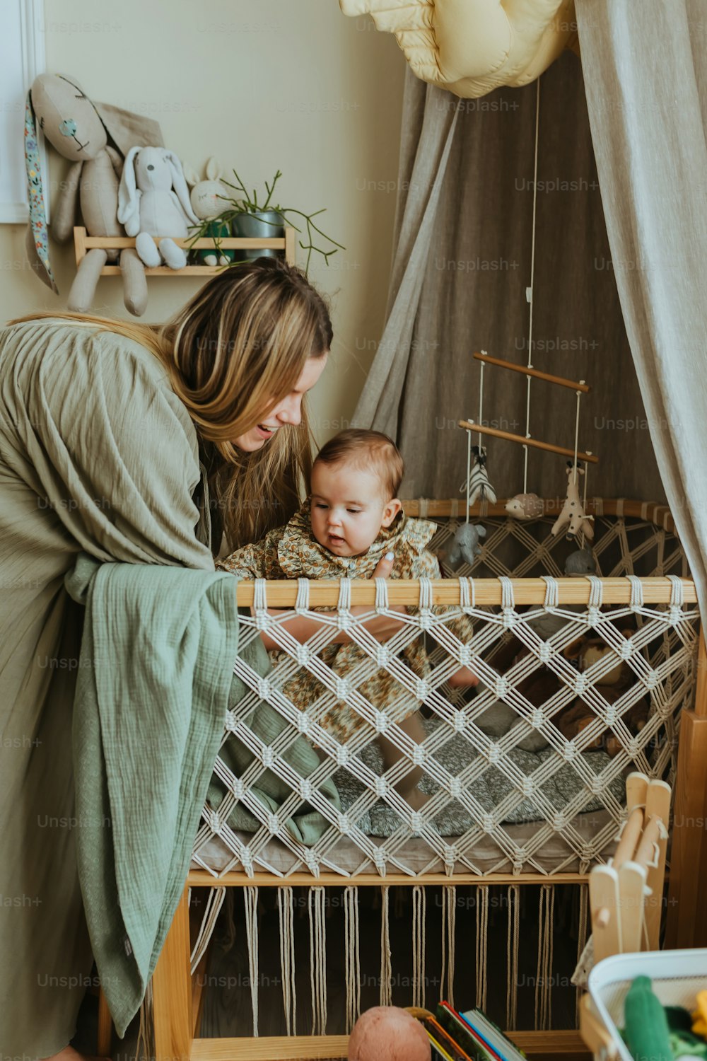 a woman holding a baby in a crib