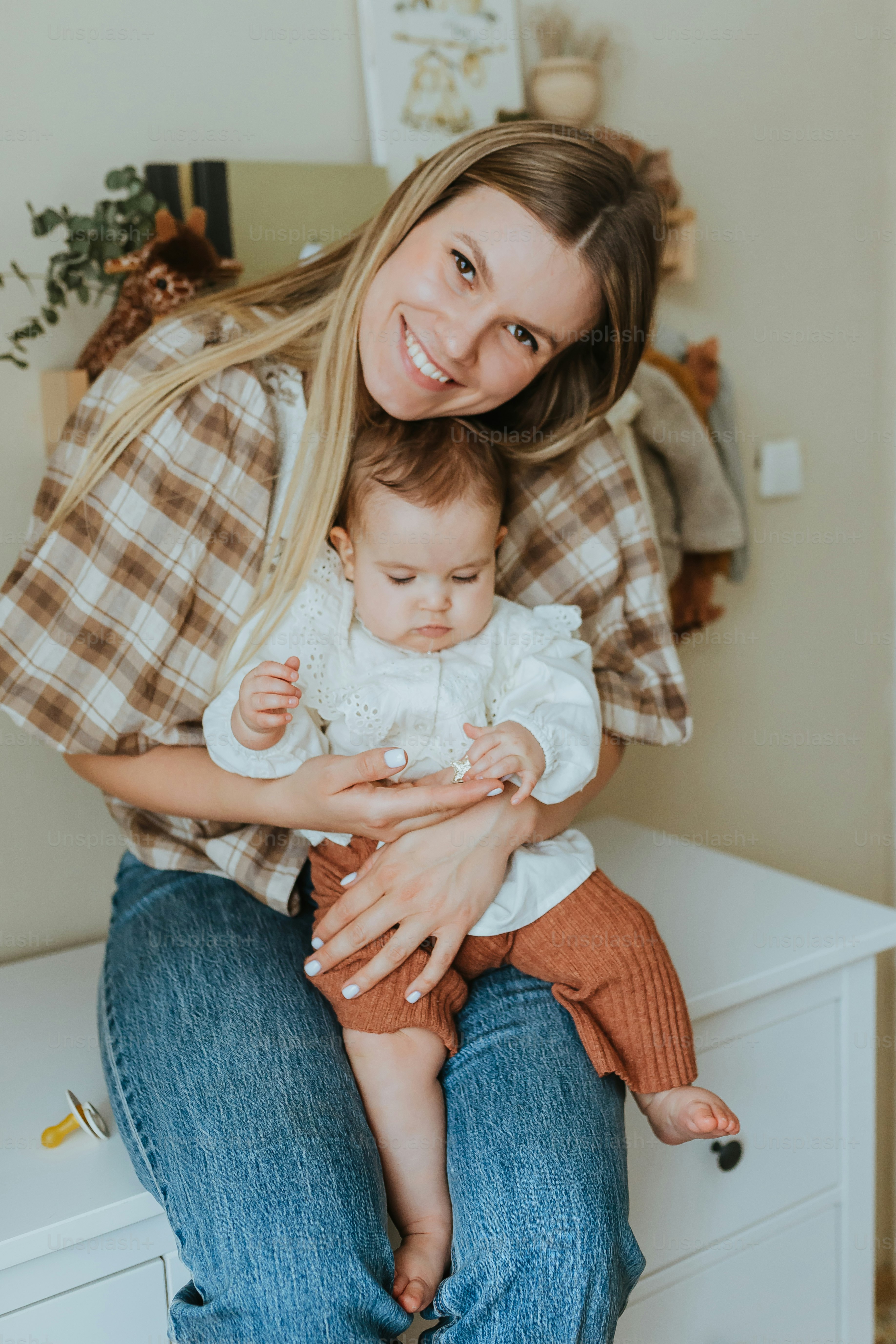 a woman holding a baby in her arms