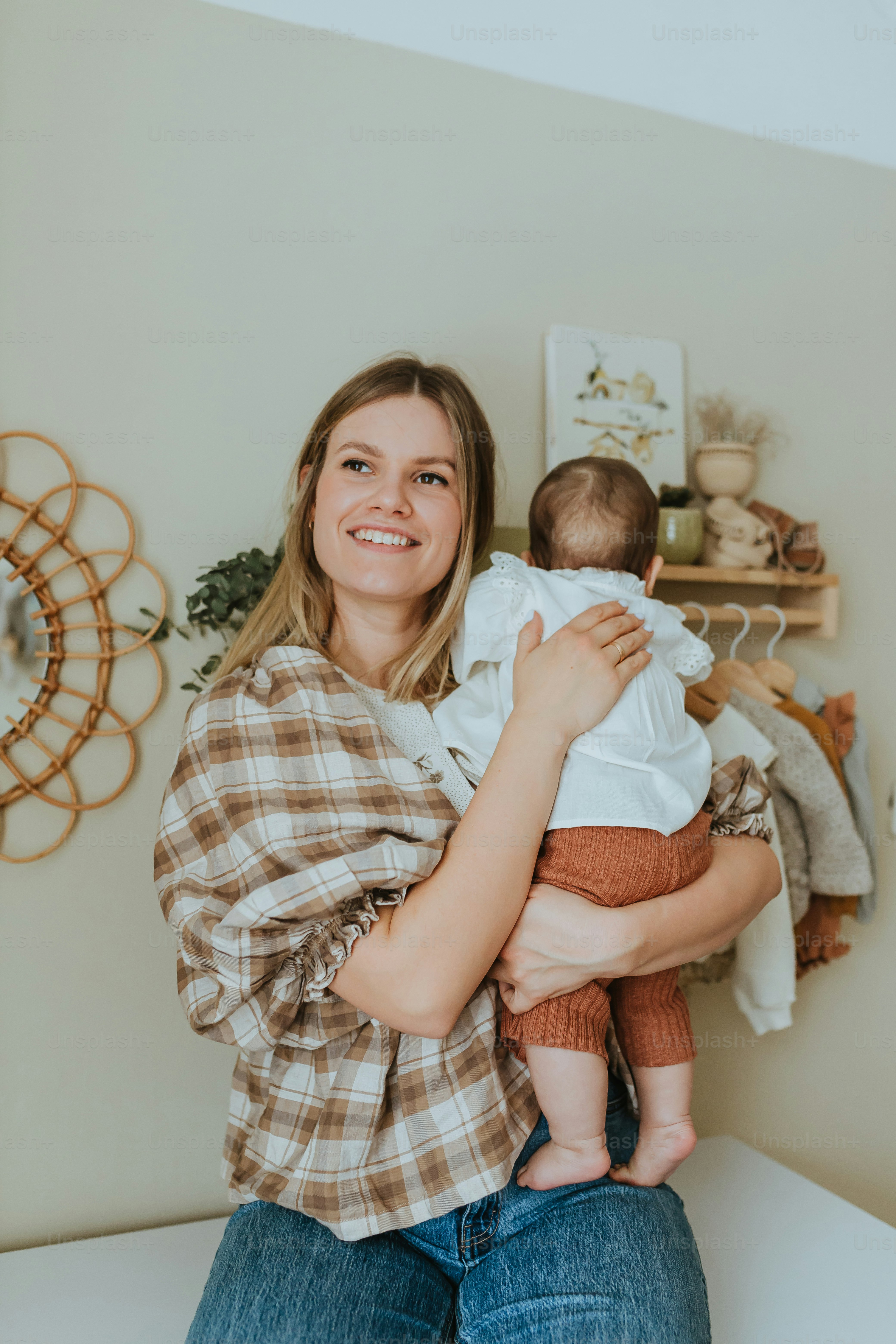 a woman holding a baby in her arms