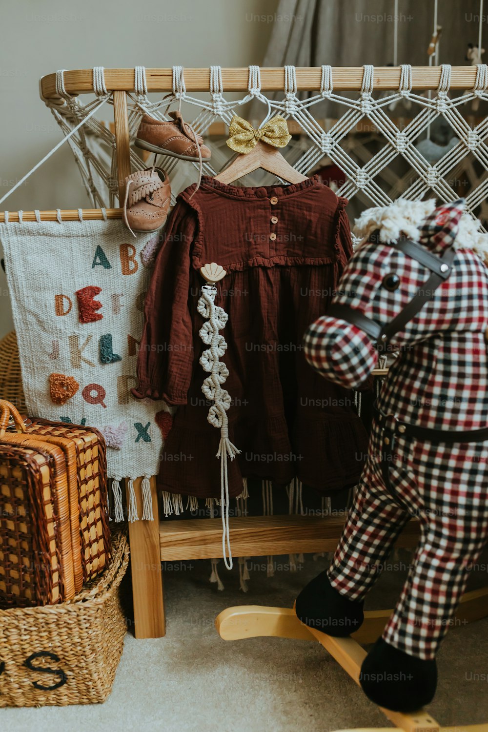 a teddy bear sitting next to a wooden rocking chair