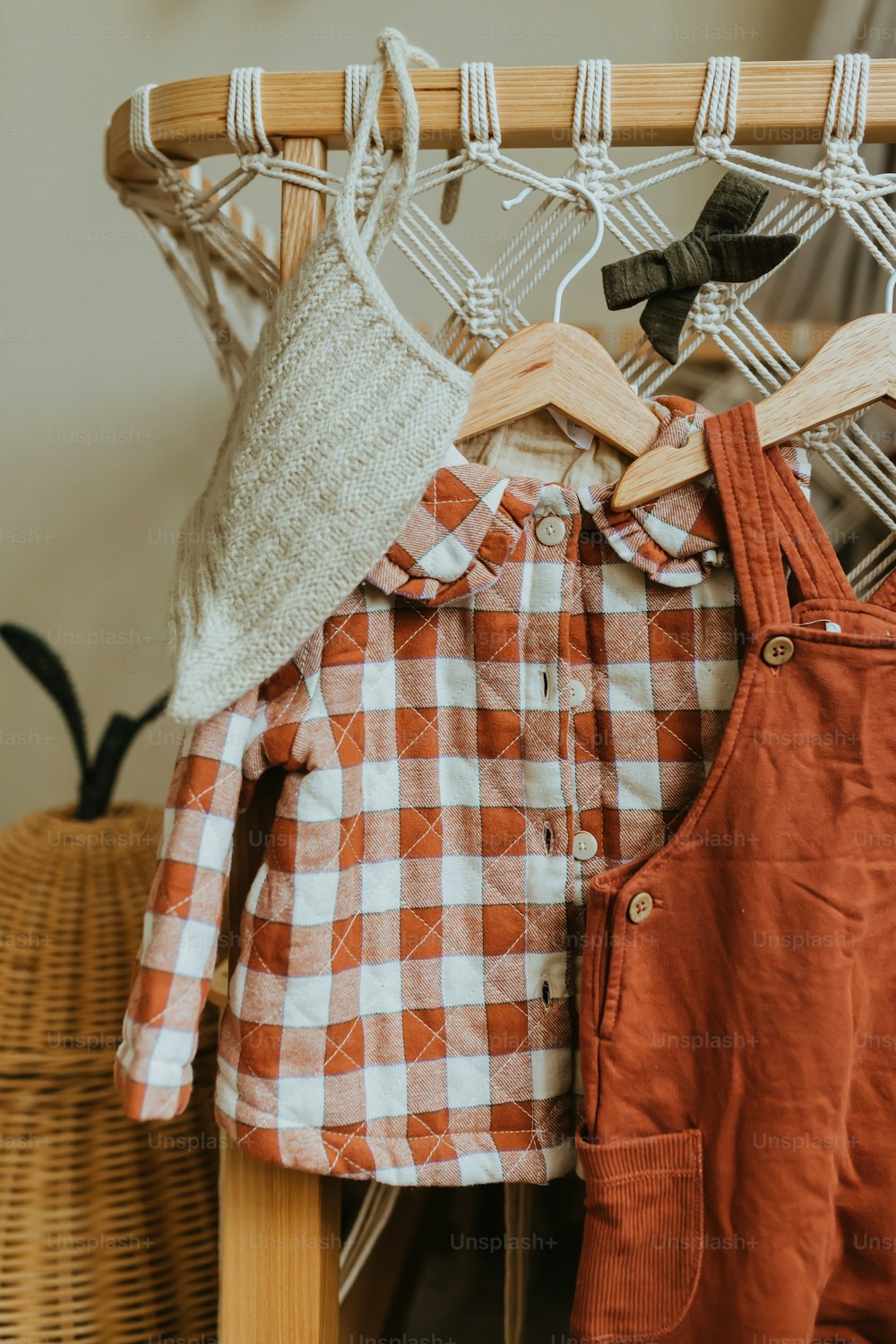 a wooden chair with clothes hanging on it