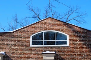 a red brick building with a white window